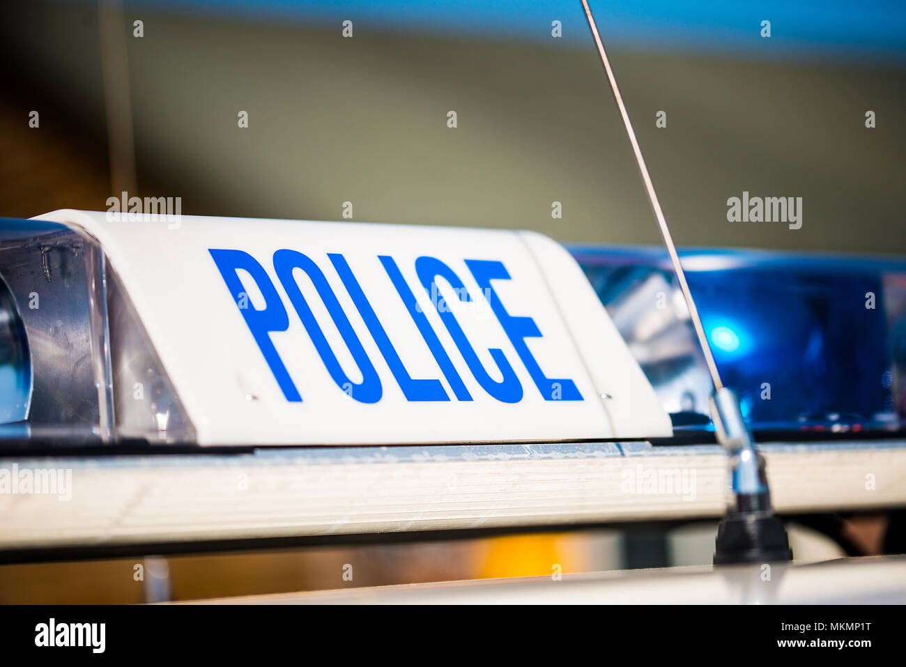 Police sign with blue lights on top of a patrol vehicle Stock Photo - Alamy