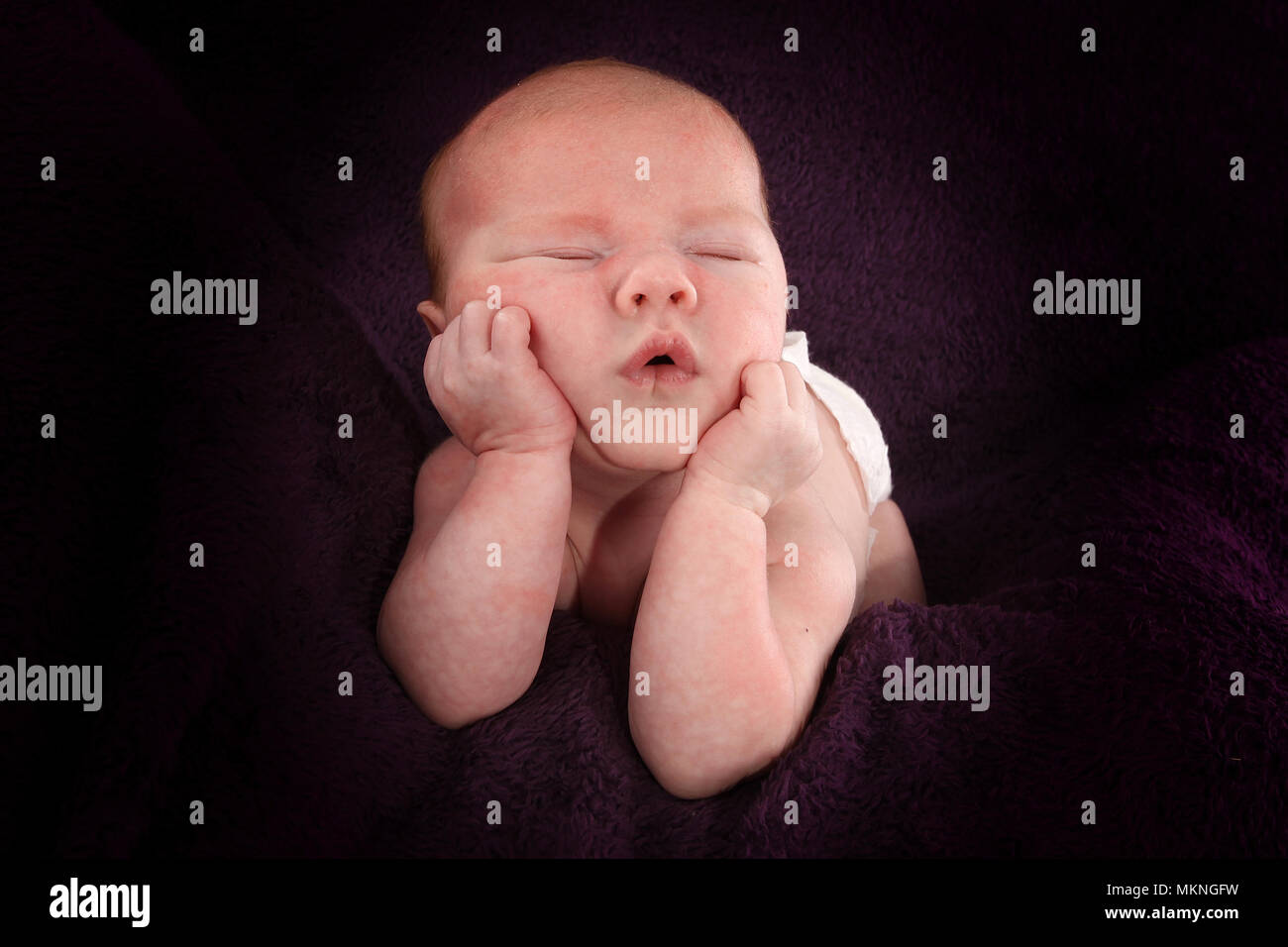 6 week old baby boy sleeping on his hands Stock Photo Alamy