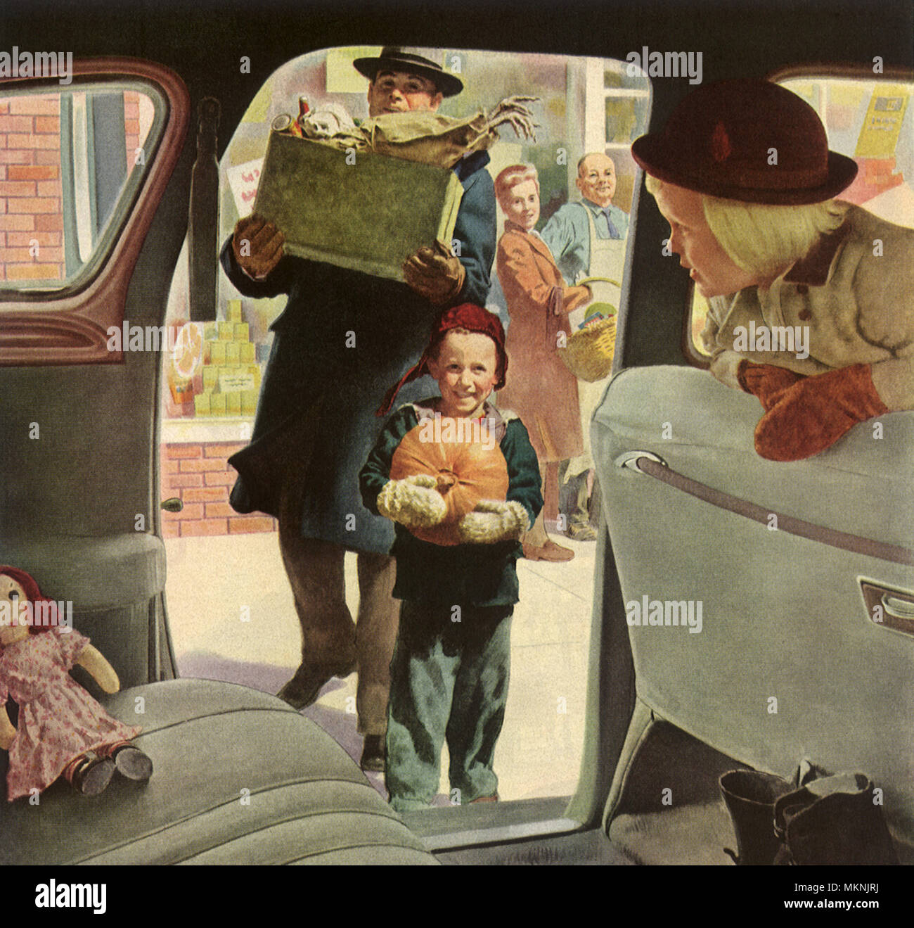 Boy carries Pumpkin into Car Stock Photo