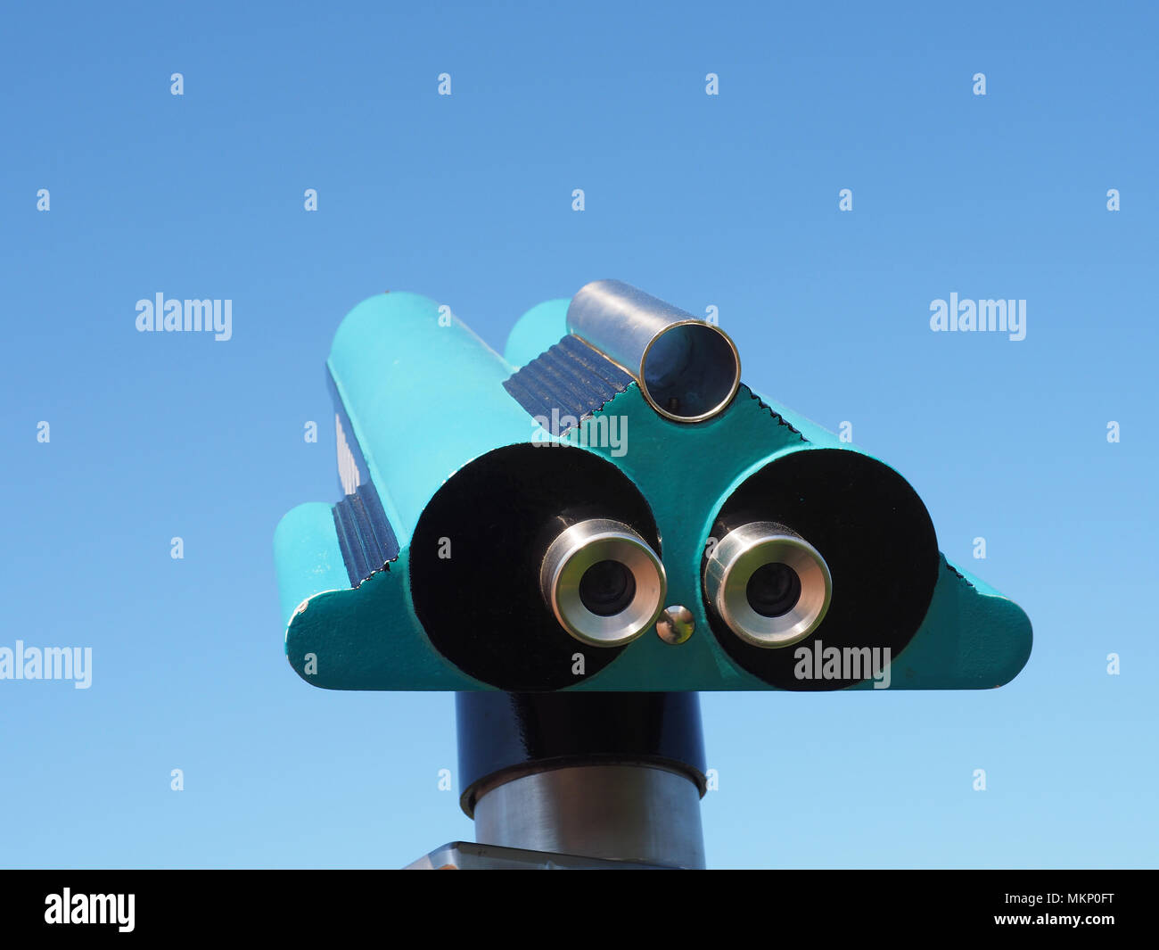 Binoculars on a blue summer sky, farsightedness concept Stock Photo