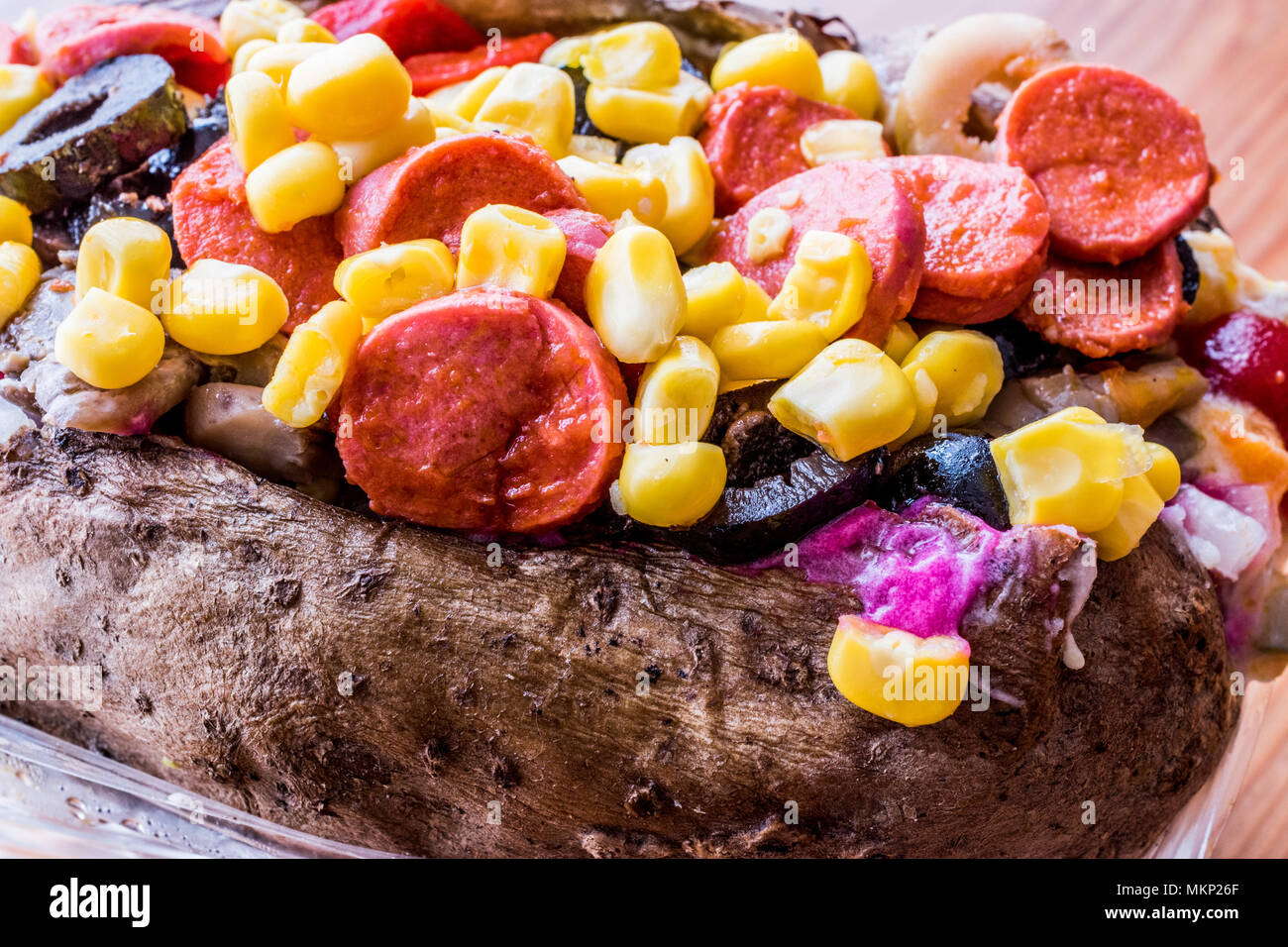 Kumpir / Turkish Baked potato with cheese, corn and sausage. fast food Stock Photo