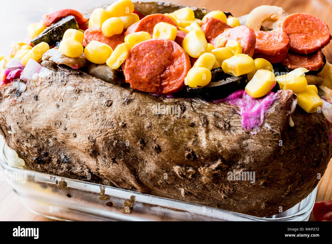 Kumpir / Turkish Baked potato with cheese, corn and sausage. fast food Stock Photo