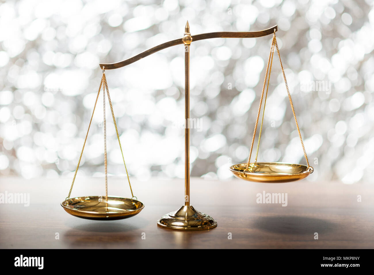 Gold brass balance scale,weight balance, imbalance scale on wooden