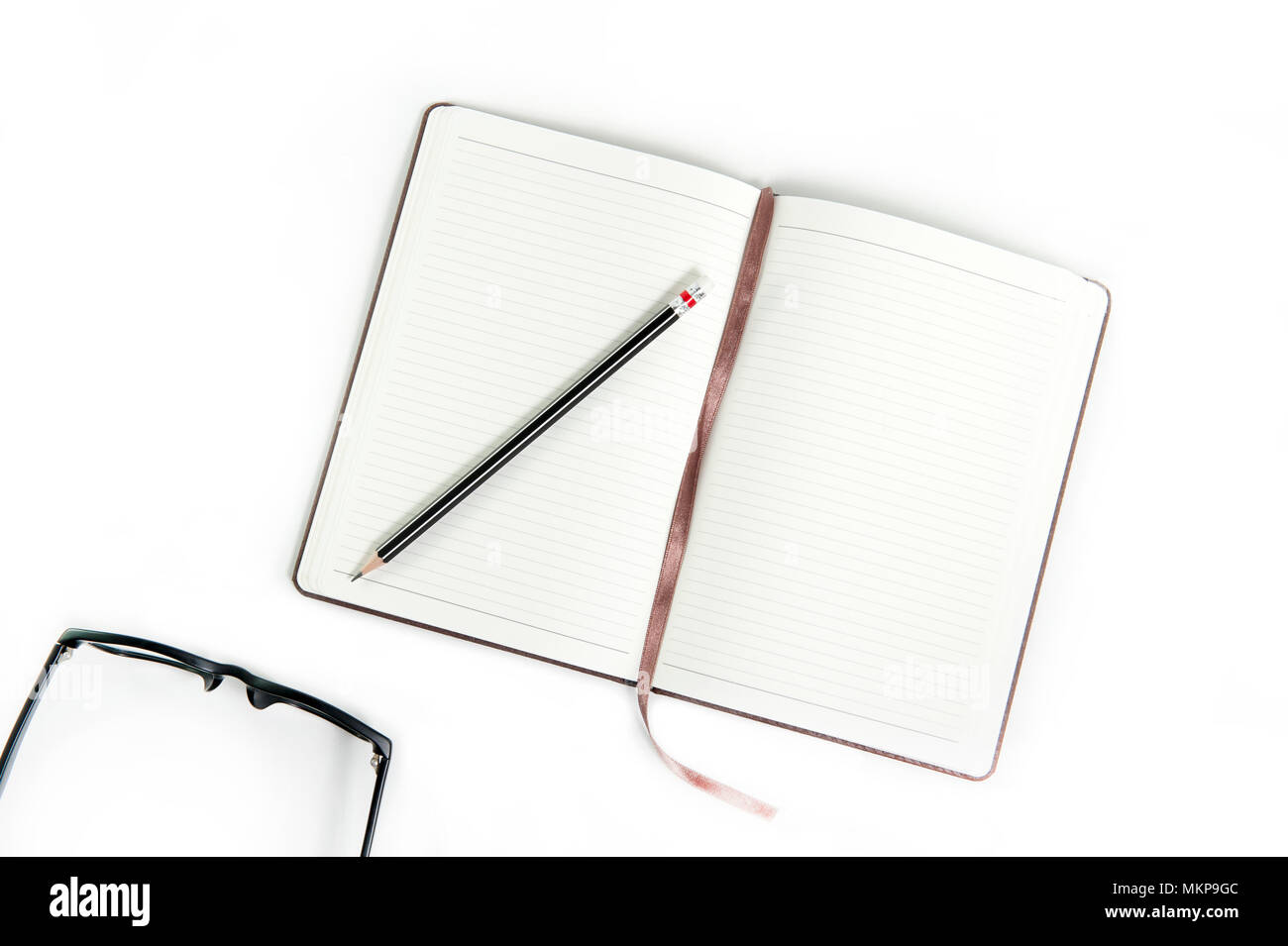 Blank open notebook diary with pencil and eye glasses on white background.  Top view Stock Photo - Alamy