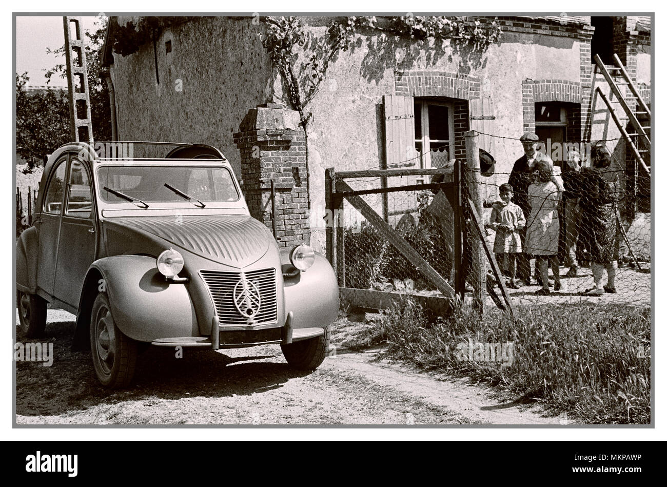 2CV VINTAGE FRENCH AUTOMOBILE 1950's Citroën 2CV deux chevaux 1950 typical notable family French car in French rural surroundings for French press advertising designed by Flaminio Bertoni: Stock Photo