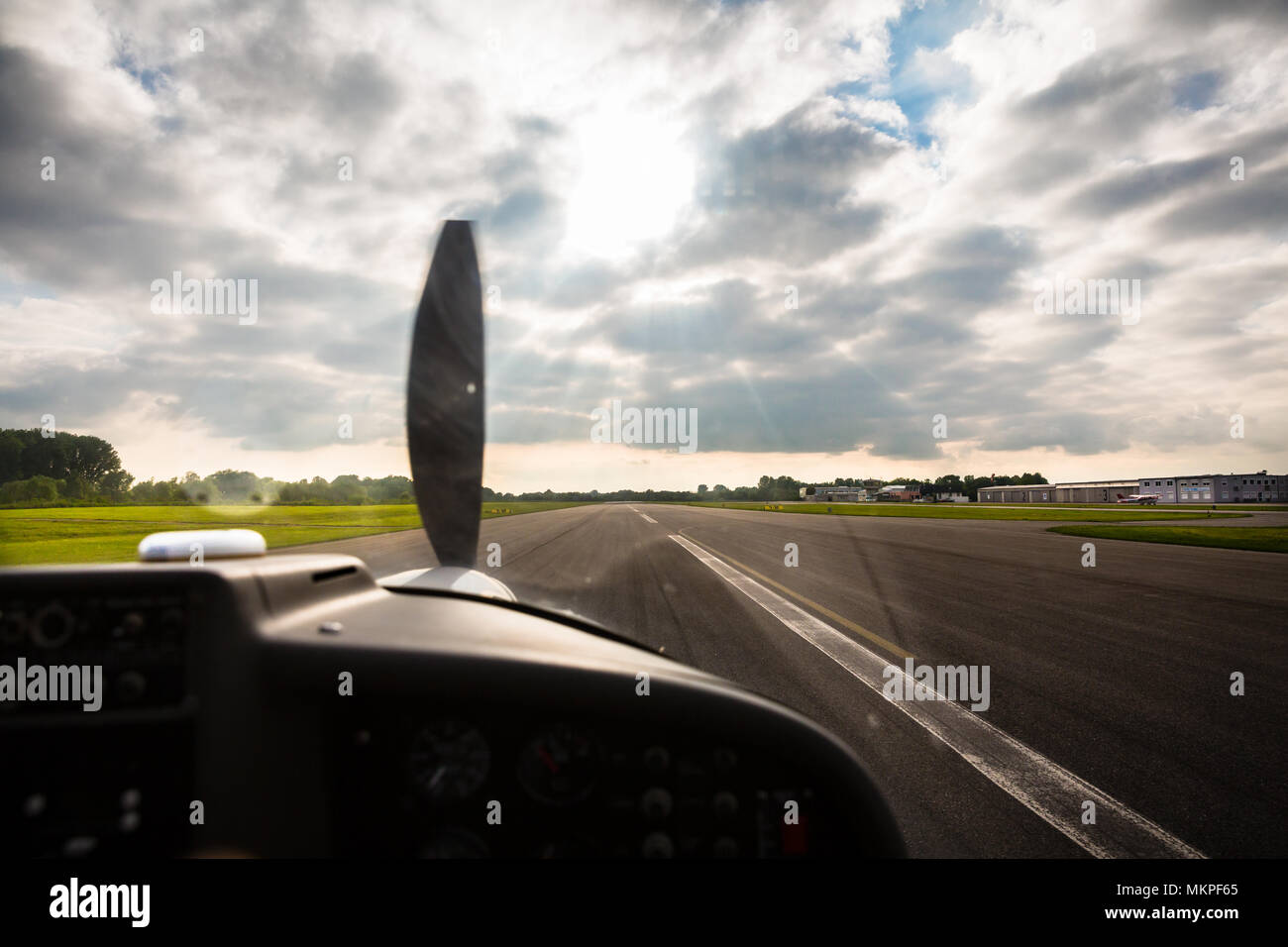 Sport pilot landing on airfield strip Stock Photo
