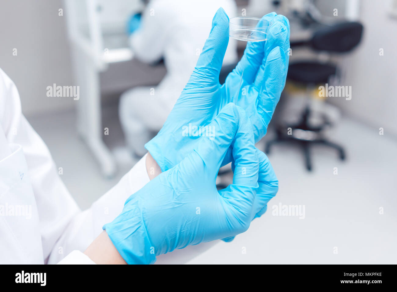 Fertility lab with technician holding tools for fertilizing human eggs Stock Photo