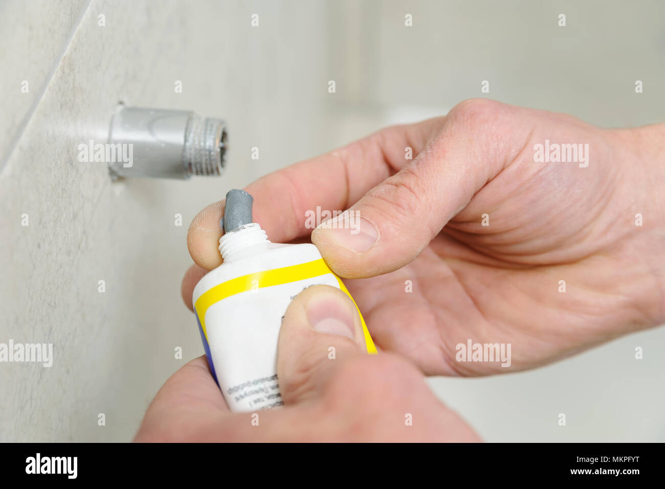 Plumber putting a paste sealant on the threads pipe Stock Photo Alamy