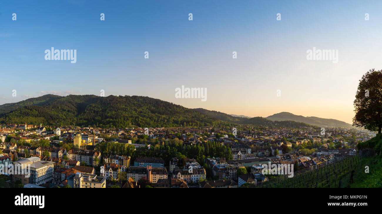 Germany, XXL panorama of city Freiburg im Breisgau at dawn in warm sunset light Stock Photo