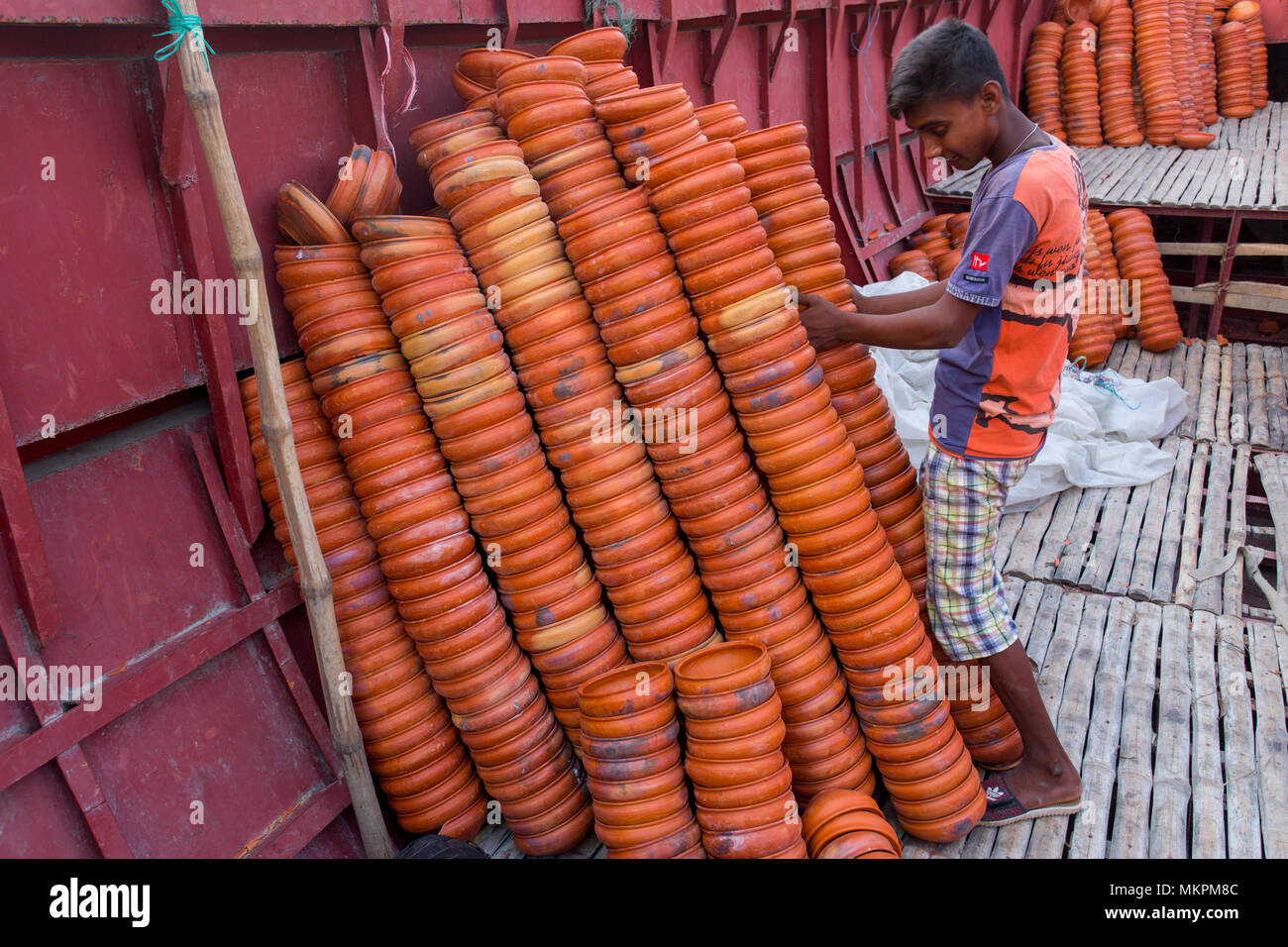 Pottery load unload on transporting boat at Burigonga River near Sadarghat, Dhaka, Bangladesh. Stock Photo