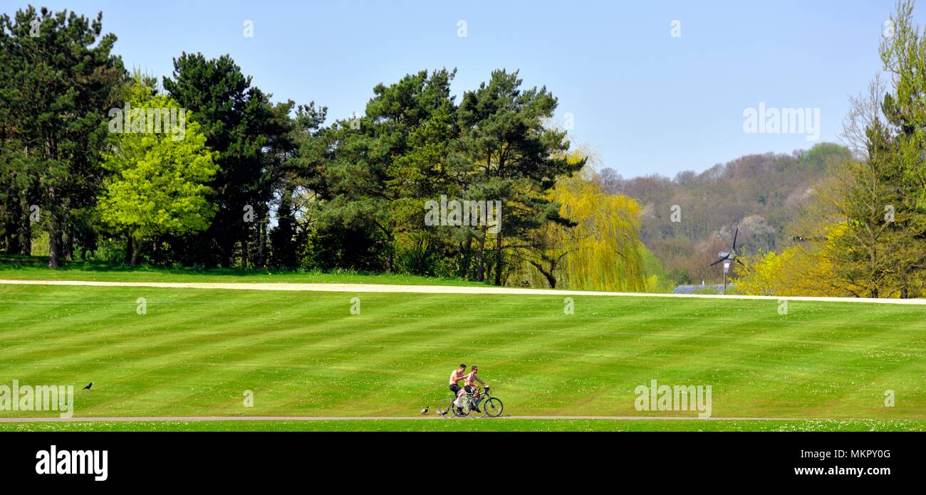 Two men cycling in the National water sports centre Holme Pierrepont country park Nottingham England UK Stock Photo