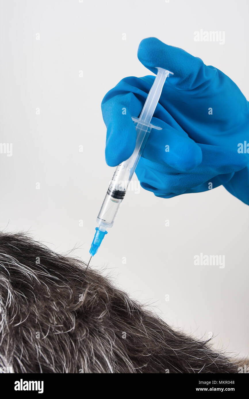 hands of veterinarian giving an injection to dog, closeup Stock Photo