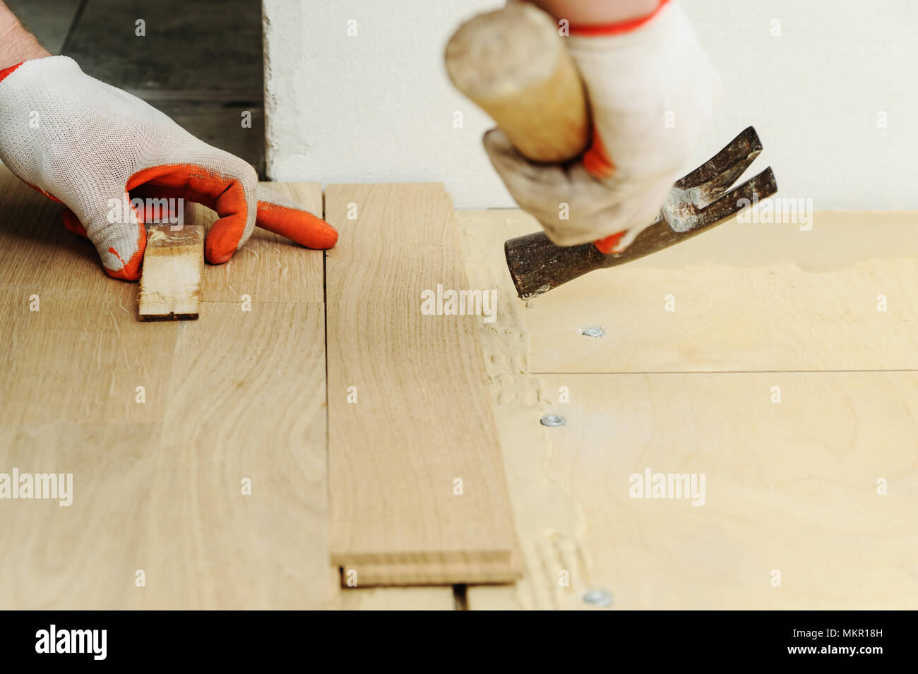 Laying Hardwood Parquet Worker Clamps Parquet With A Hammer Stock