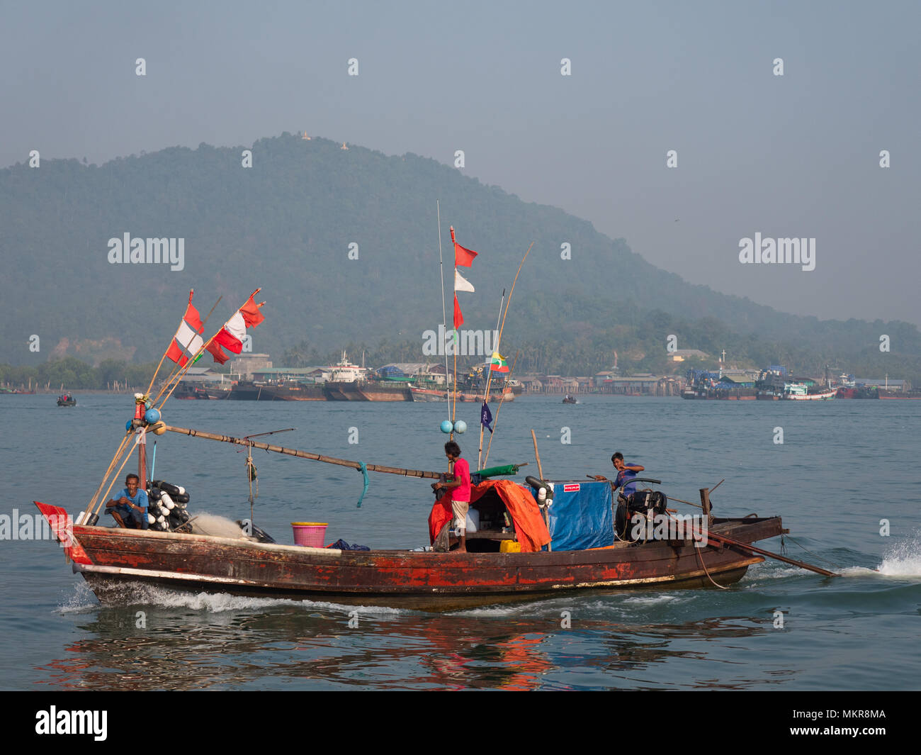 Fishing vessels in Myeik, formerly Mergui, the largest city in the Tanintharyi Region of Myanmar. Pataw Island in the background. Stock Photo