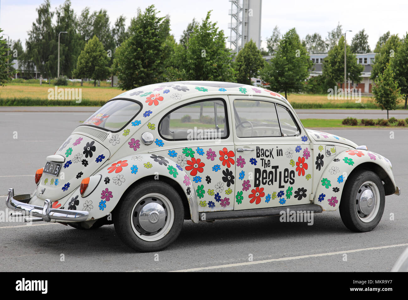 Back in the Beatles Volkswagen Beetle, officially the Volkswagen Type 1, painted with floral design to celebrate the International Beatles event in La Stock Photo