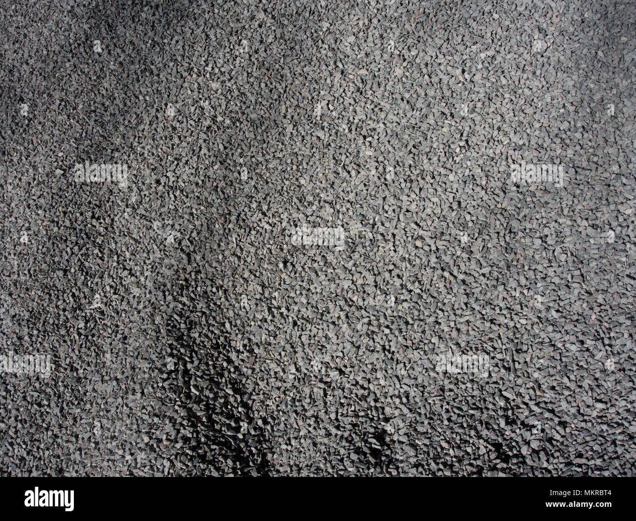 Gravel with asymetric shadows Stock Photo - Alamy