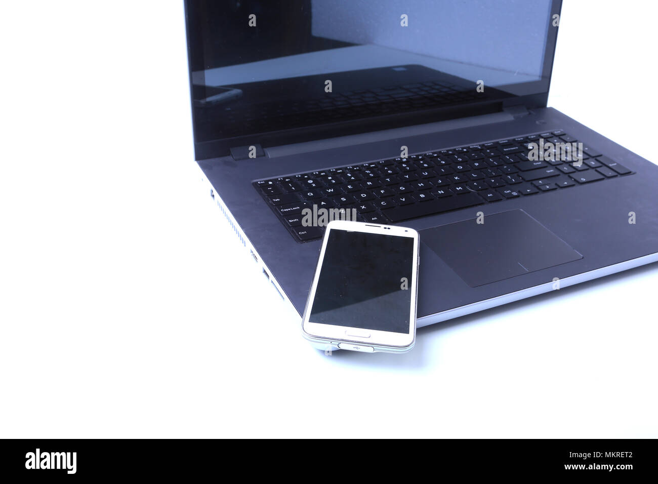 Office workplace with laptop, smart phone on table. Stock Photo