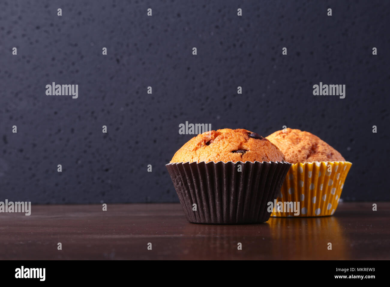 Tasty chocolate cupcakes, muffins on a white wooden table. Stock Photo