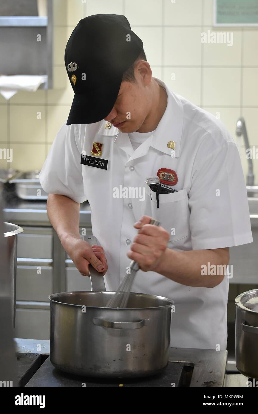 U.S. Army Spc, May 3, 2018. Arthur Hinojosa, a culinary specialist with Fury Battery, 4th Battalion, 319th Airborne Field Artillery Regiment, 173rd Airborne Brigade, prepares a meal at the Tower Barracks Dining Facility, Grafenwoehr, Germany, May 3, 2018. (U.S. Army photo by Gertrud Zach). () Stock Photo