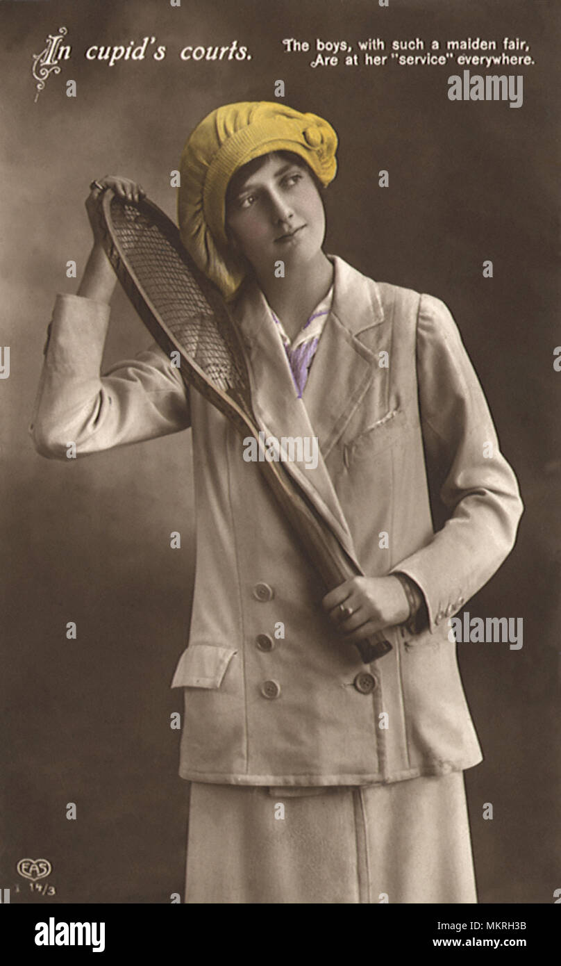 Woman in coat and hat with tennis racquet Stock Photo