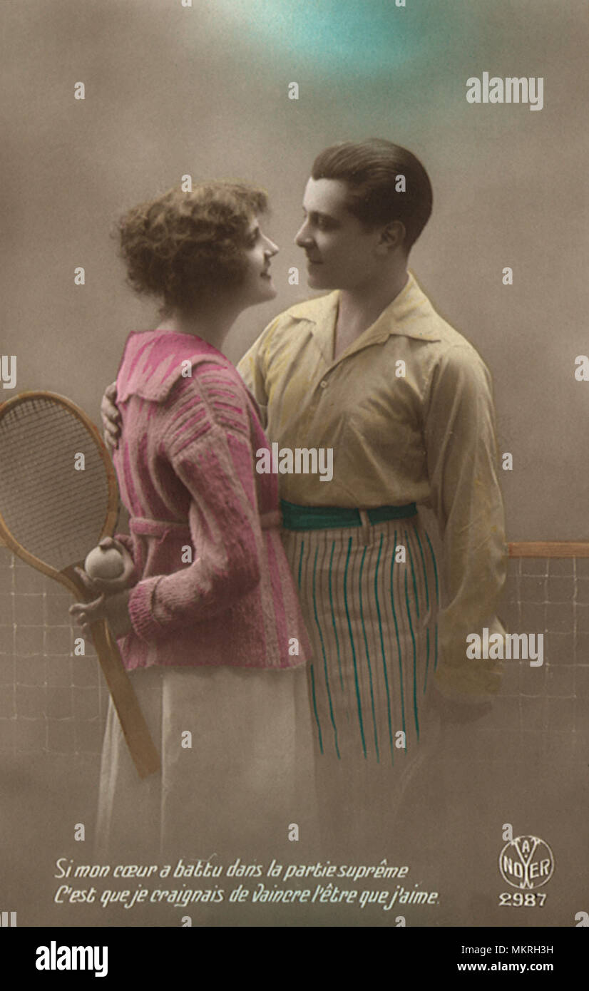 French Couple in tennis outfits by net Stock Photo