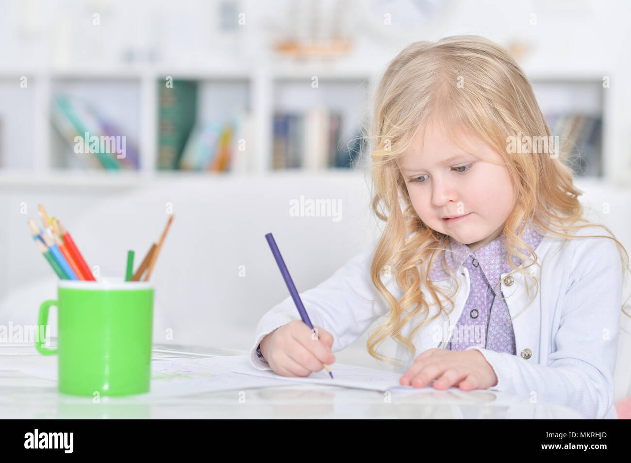 Portrait of cute little girl drawing with pencils Stock Photo - Alamy