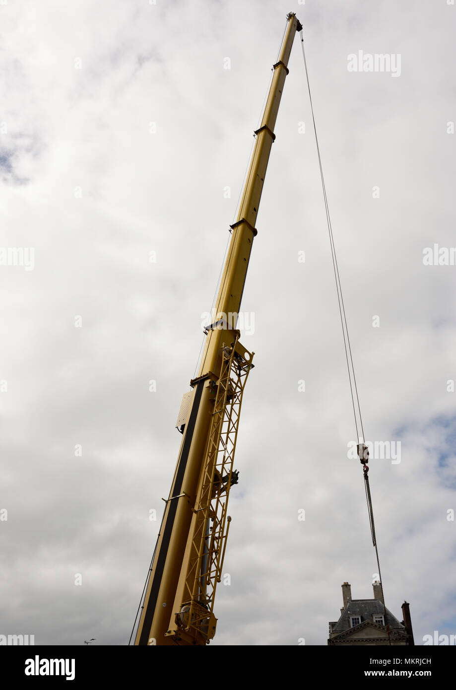 telescopic crane boom extended with steel lifting rope under load in ...