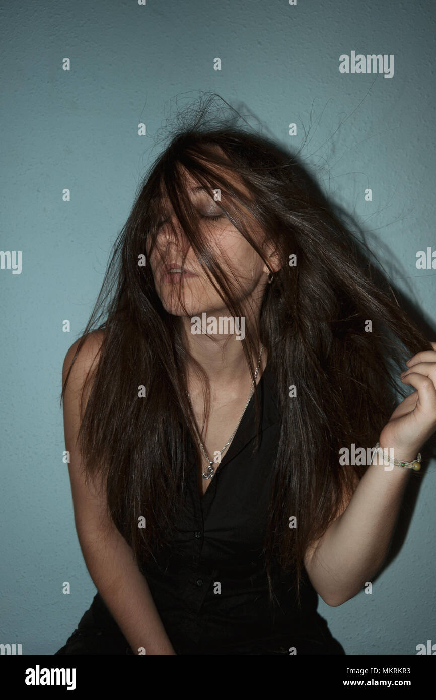 thoughtful girl with closed eyes and hair on her face Stock Photo Alamy