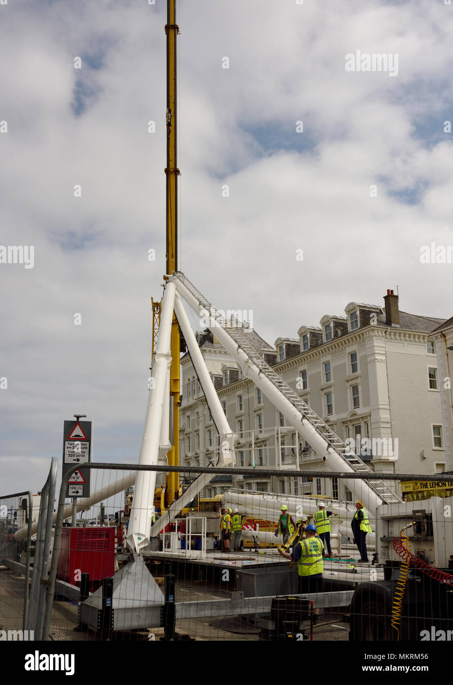 Mobile crane lifting steel framework into position in Llandudno north