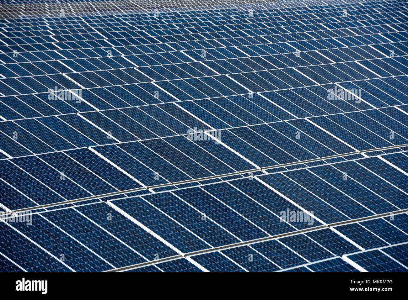 Close up of a row of solar panels in an open field with multiple solar energy panels, Calasparra, Murcia, Spain Stock Photo
