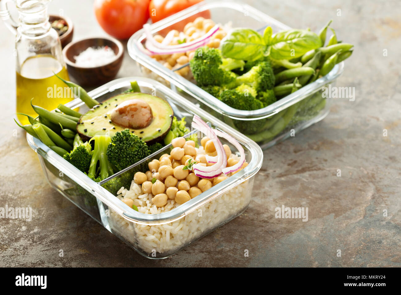 Vegan meal prep containers with cooked rice, chickpeas and vegetables Stock Photo