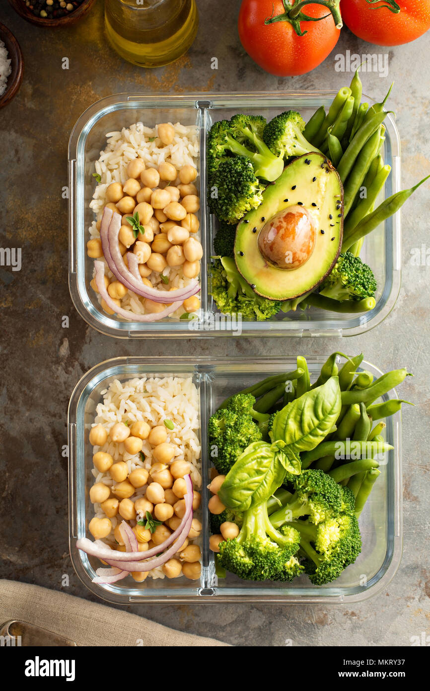 Vegan meal prep containers with cooked rice, chickpeas and vegetables Stock Photo