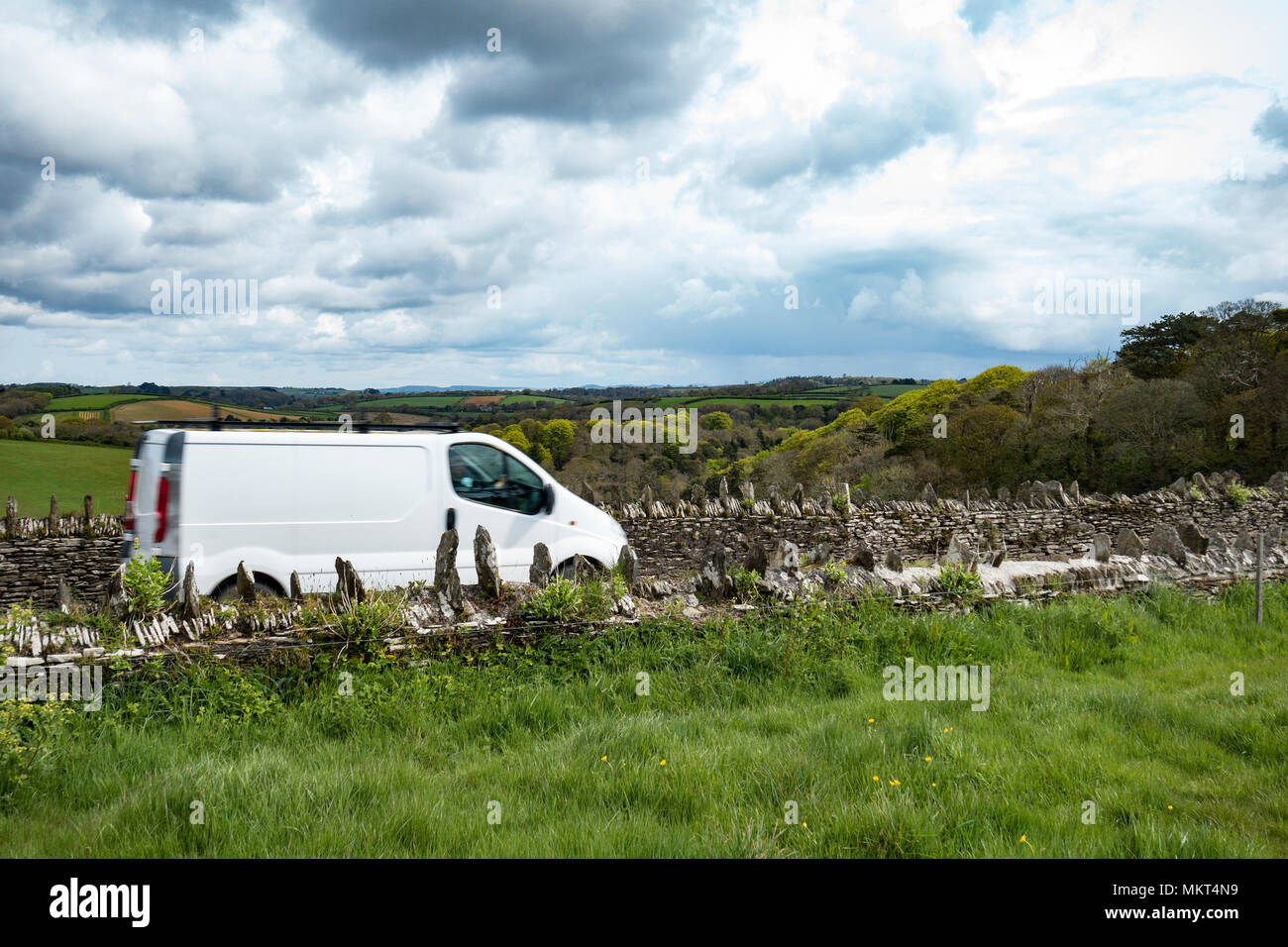 white delivery van speeding on a country lane in cornwall, england, britain, uk. Stock Photo