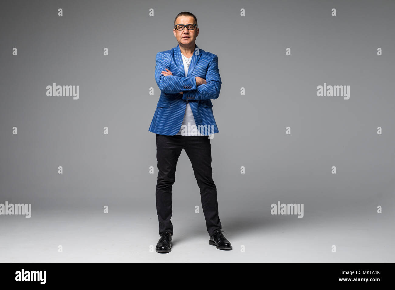 Full length portrait of confident mature businessman in formals ...