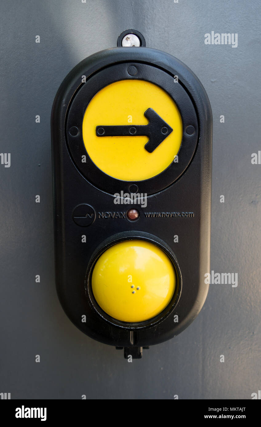 Button with arrow on a traffic signal that can be pressed to request to cross the street Stock Photo