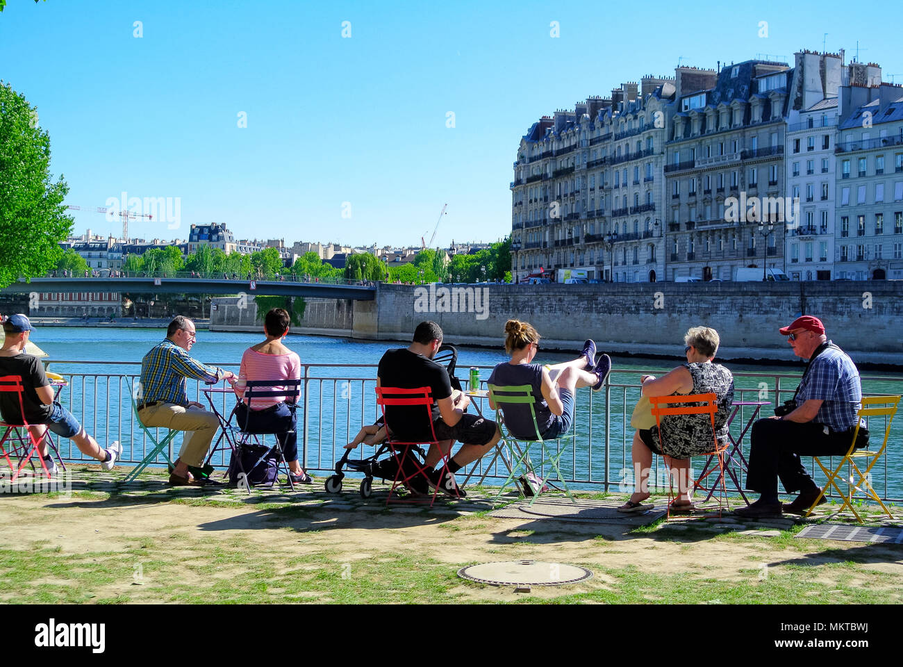 People sitting on a chaire along seine river, paris, france Stock Photo