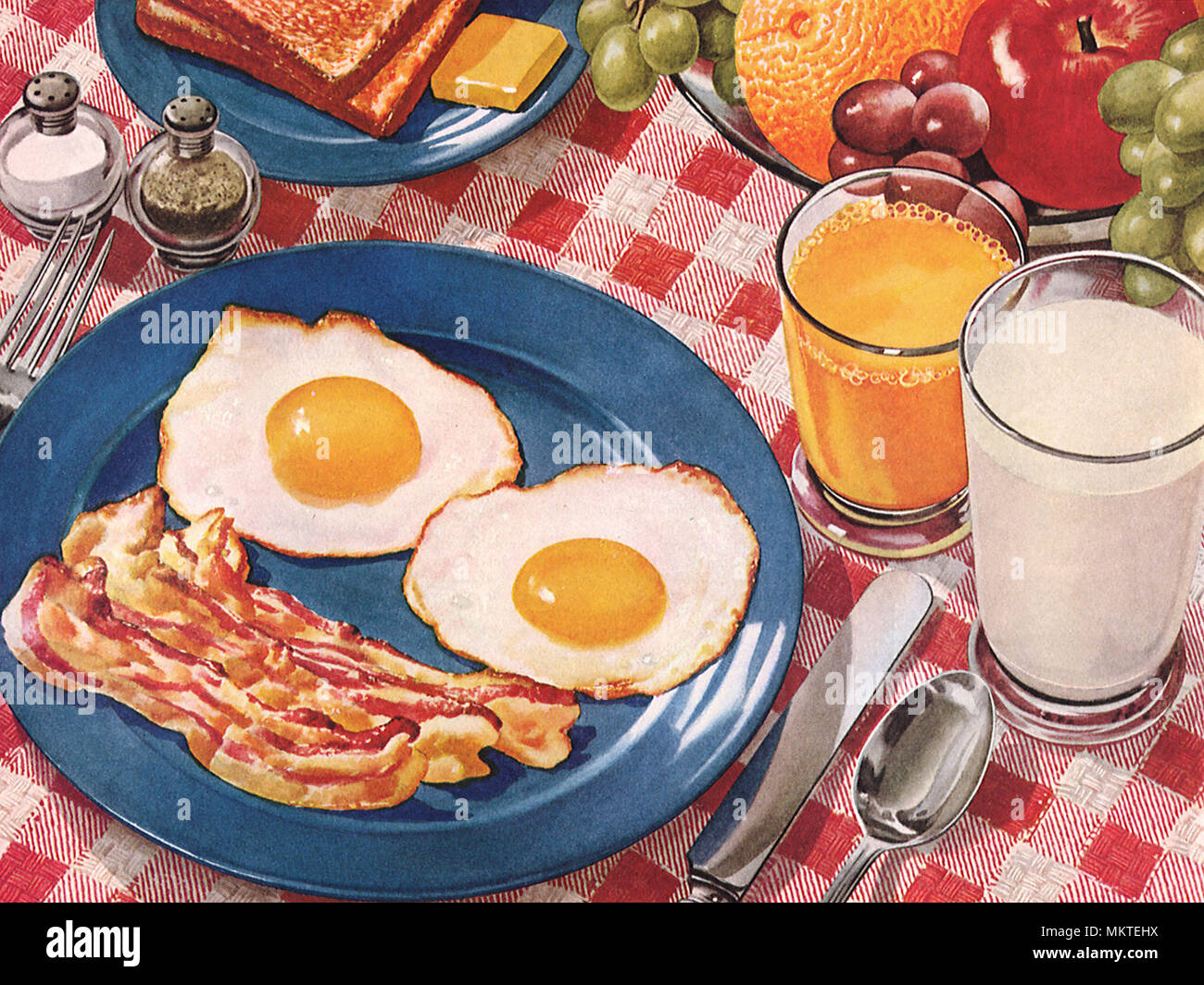 Breakfast with Bacon, Eggs, Toast, Orange Juice and Milk Stock Photo