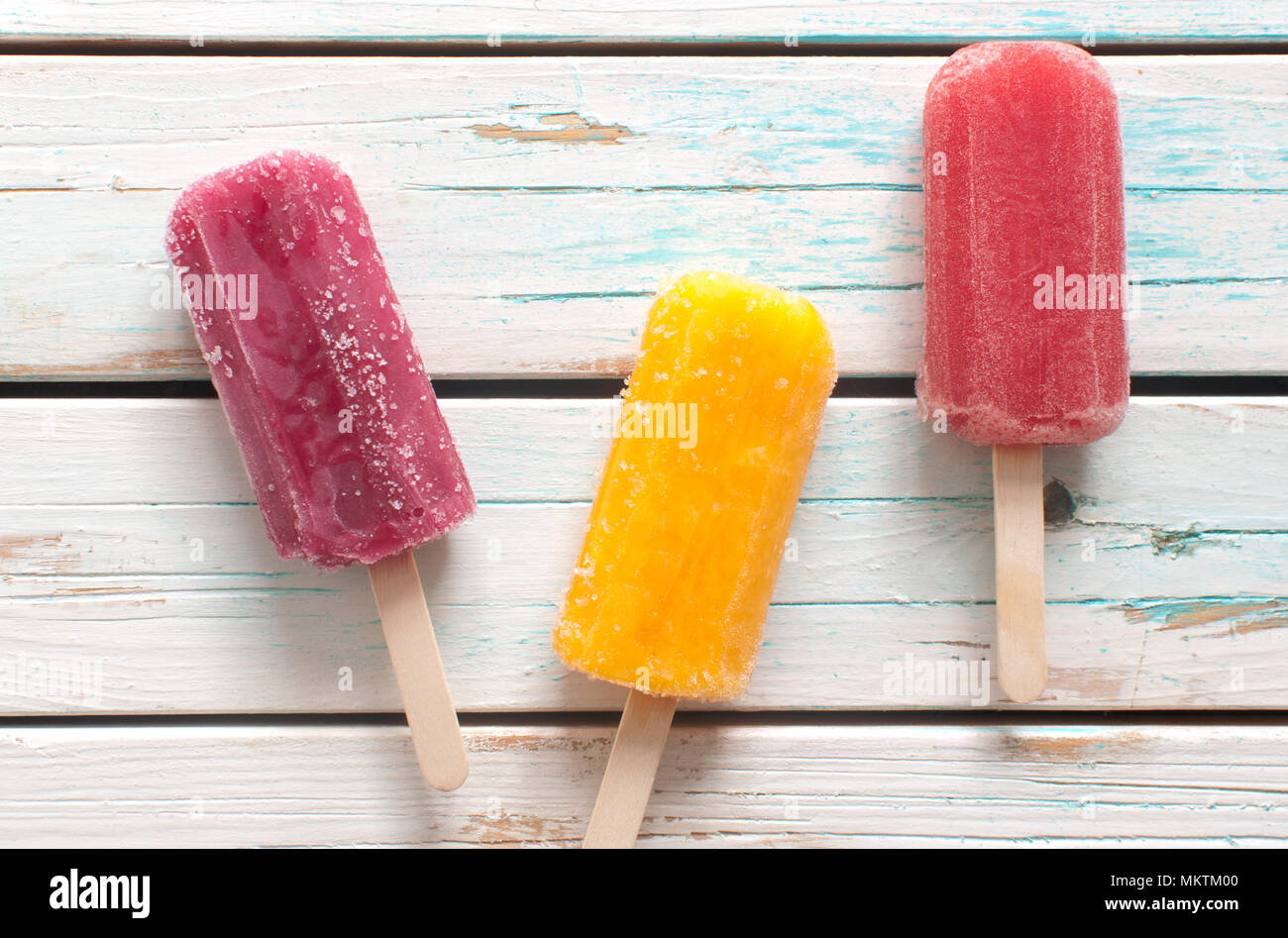 Assorted flavored ice lollies over a wooden background Stock Photo Alamy