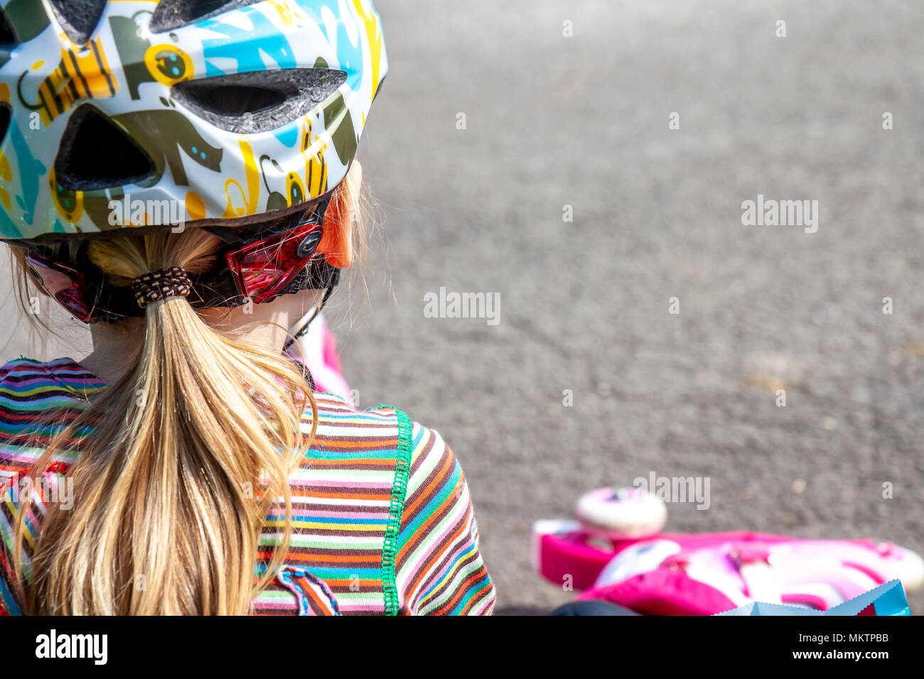 Boy and girl wearing rollerblades sitting and eating and drinking