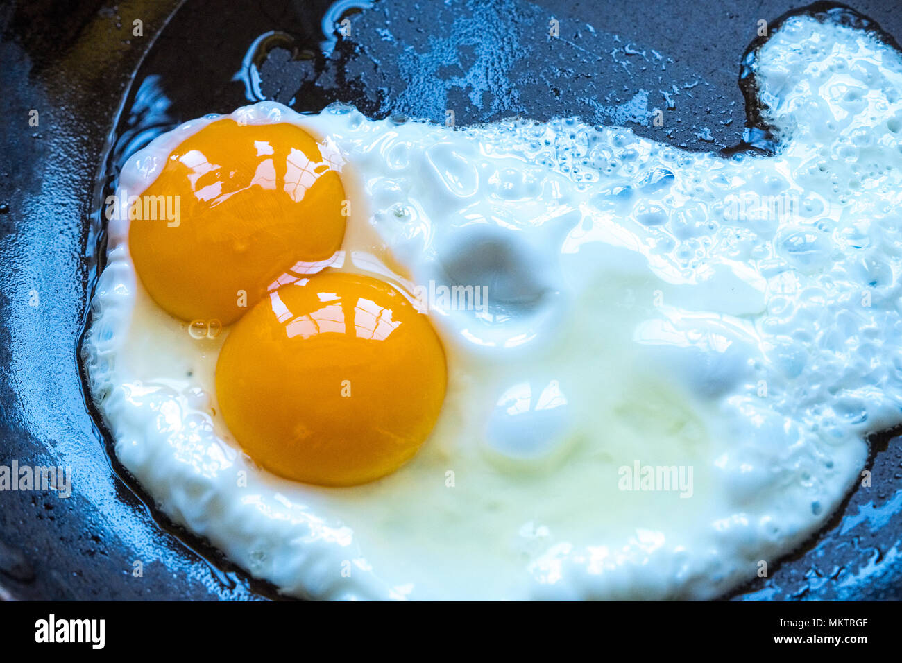 A double yoke egg frying in a pan Stock Photo