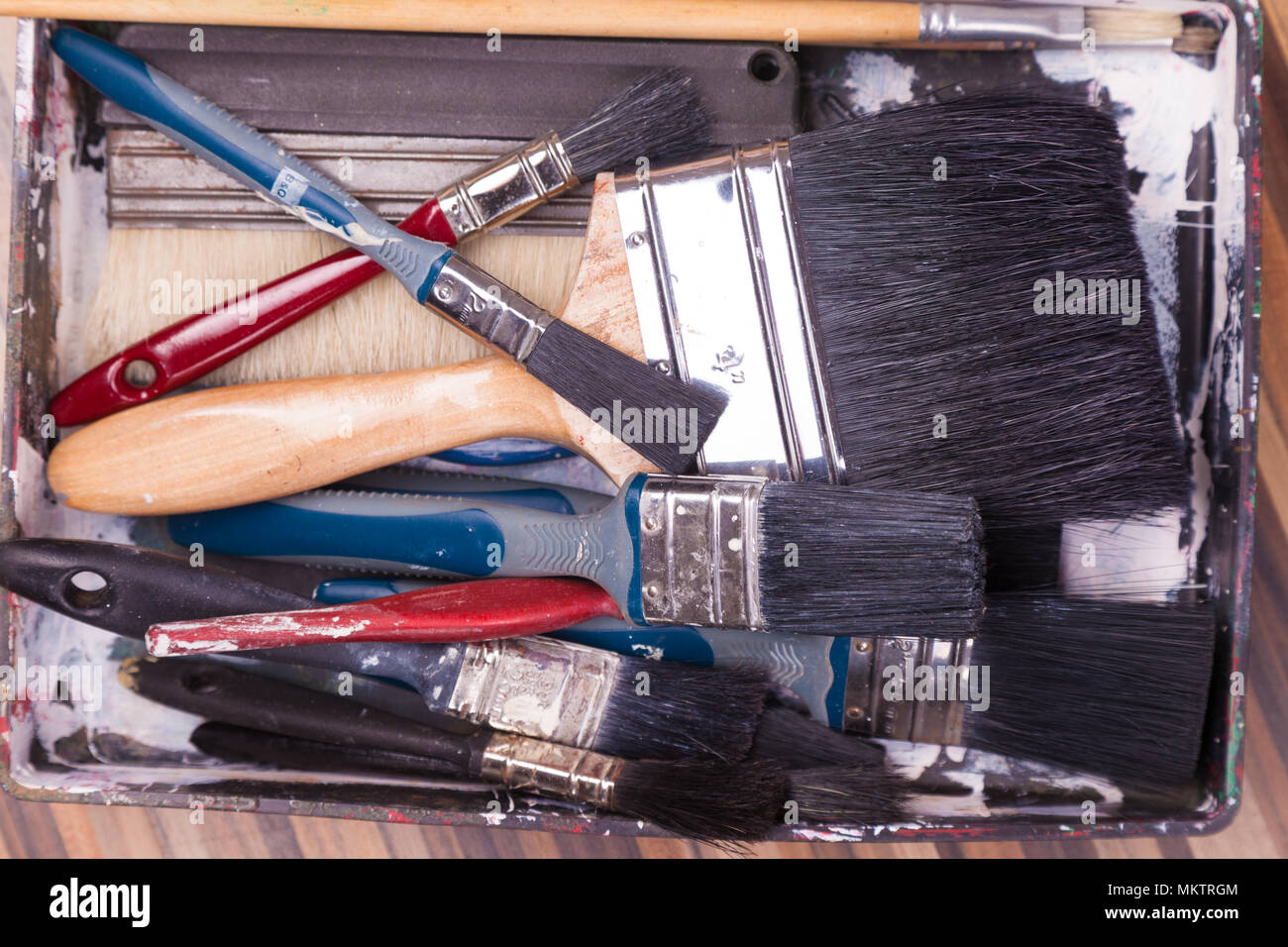Lots of decorating paint brushes viewed from above. Stock Photo