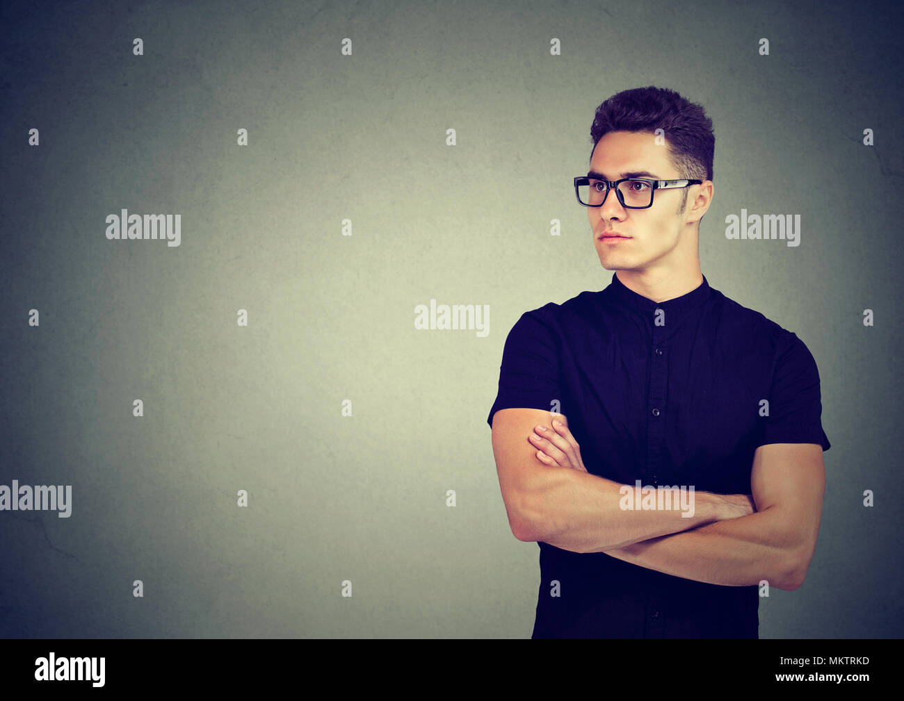profile of handsome man in glasses on gray background Stock Photo