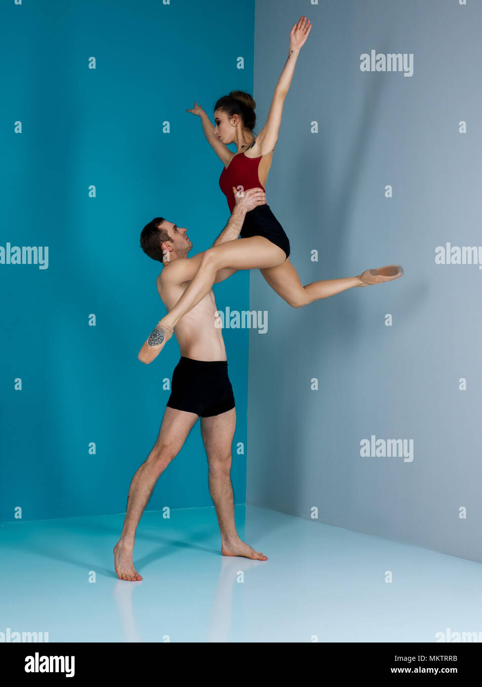 Modern ballet dancer couple in black form performing art jump with empty copy space background, izolated space Stock Photo