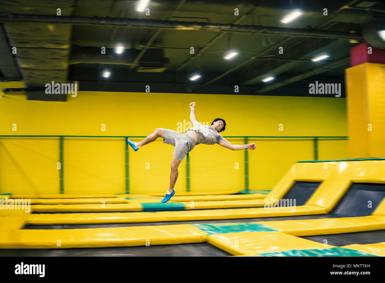 trampoline jumper performs acrobatic exercises on the trampoline Stock