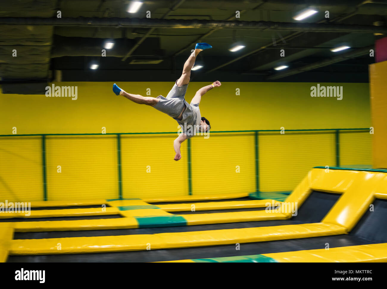 trampoline jumper performs acrobatic exercises on the trampoline Stock Photo