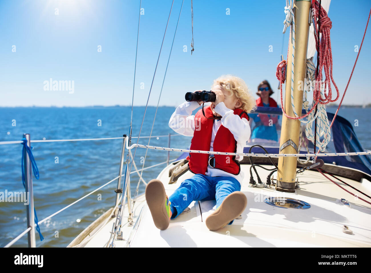 Kids sail on yacht in sea. Child sailing on boat. Little boy in safe
