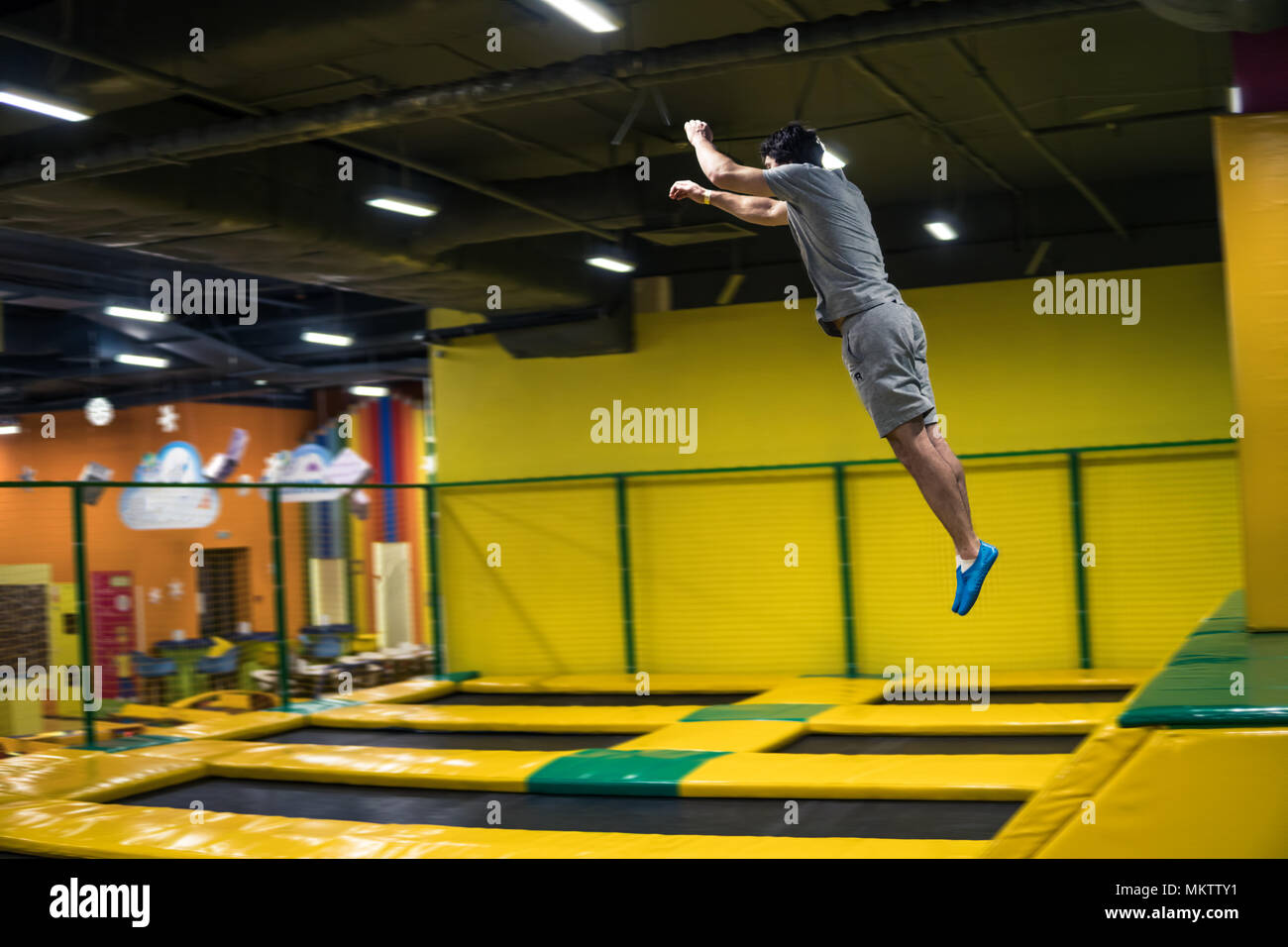 trampoline jumper performs acrobatic exercises on the trampoline Stock