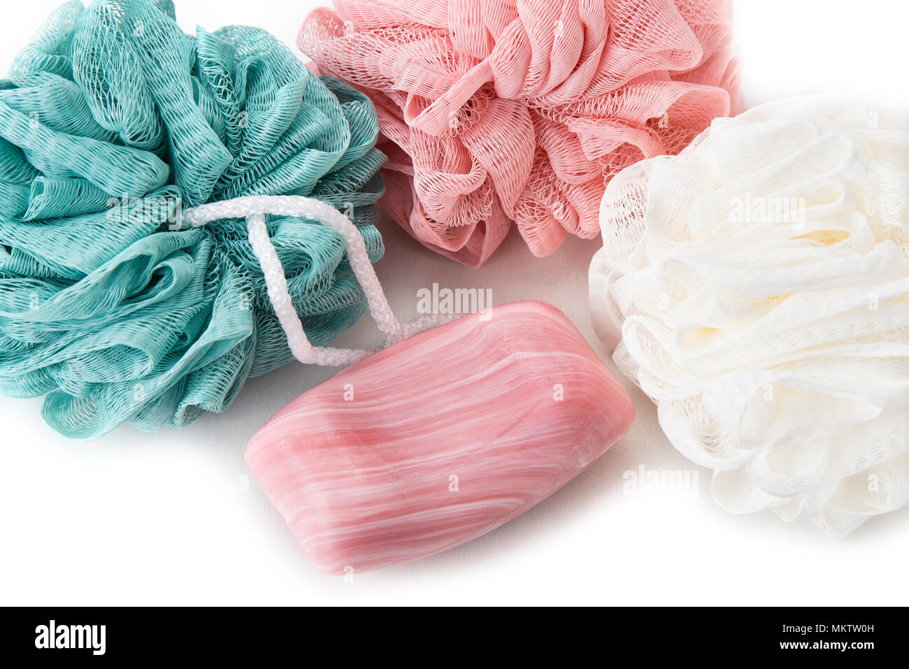 Bath sponges with soap and towel on the white background Stock Photo
