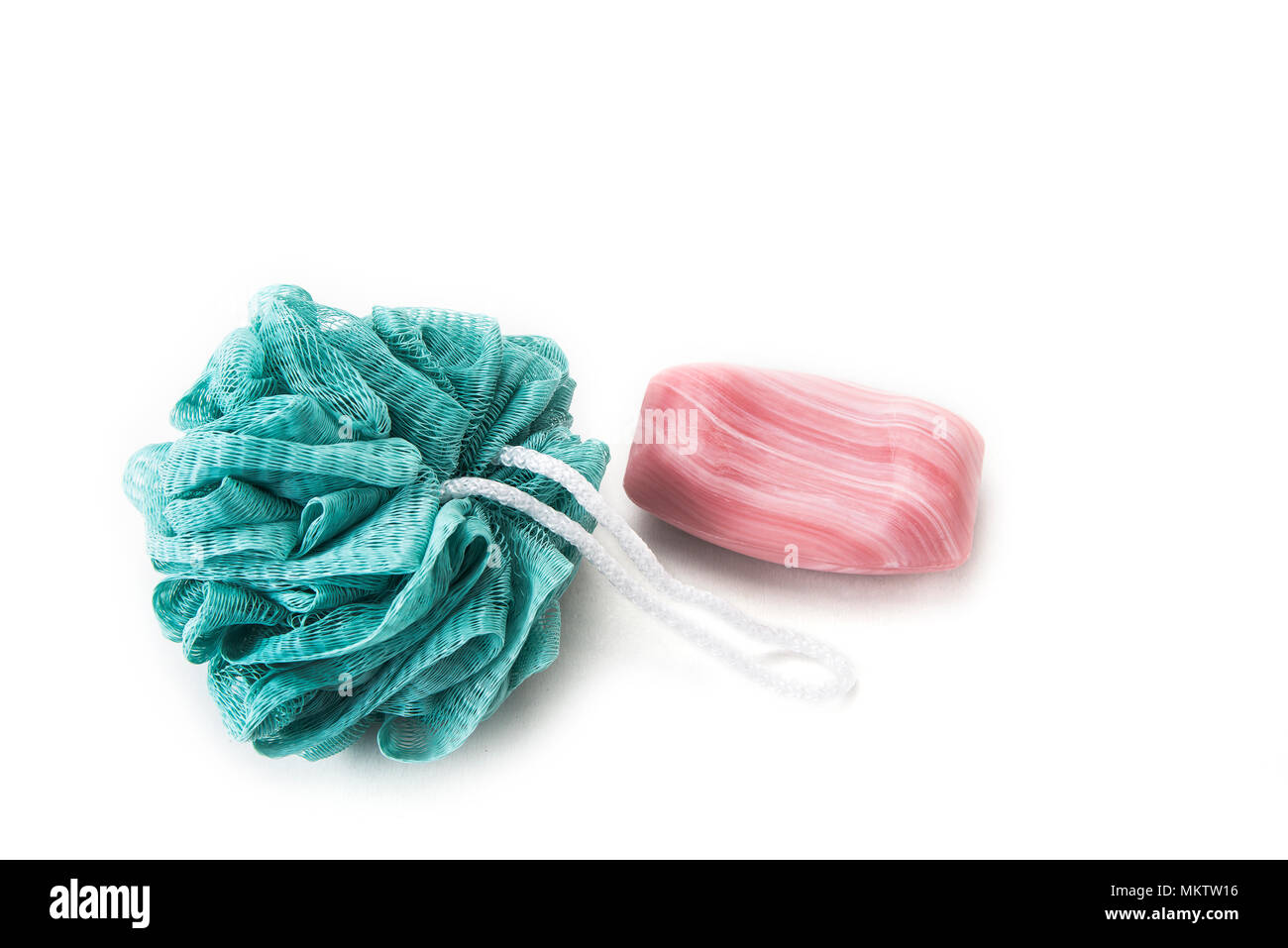 Bath sponges with soap and towel on the white background Stock Photo