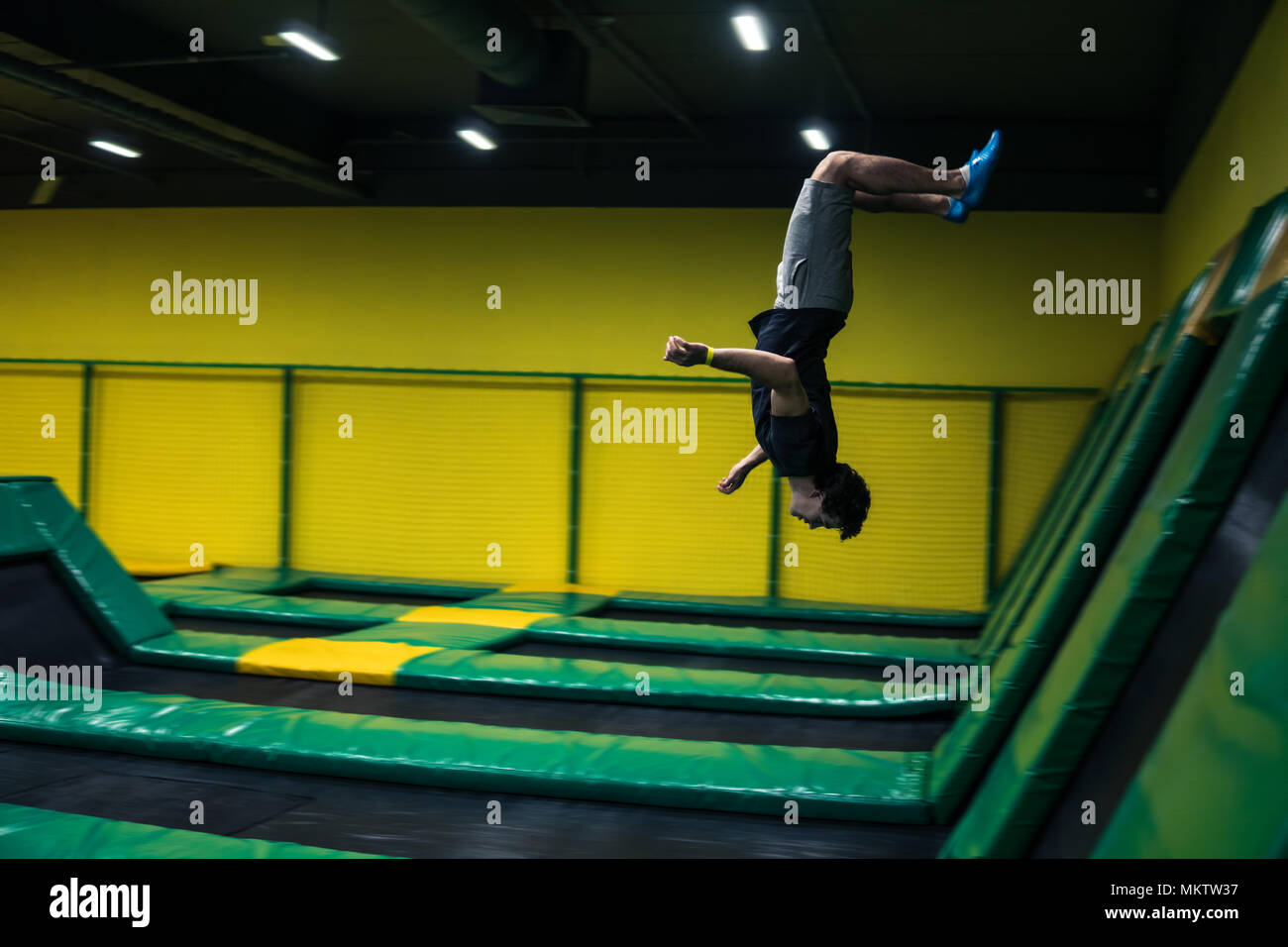 trampoline jumper performs acrobatic exercises on the trampoline Stock